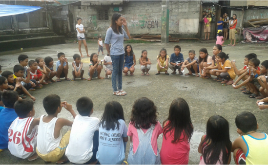 Teaching children in slum area in the Philippines