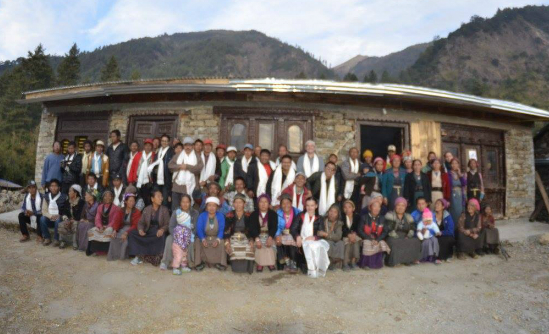 The villagers outside the newly rebuilt community centre